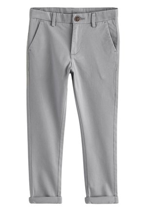 Pohľad zblízka na zložené sivé látkové rukávy s rebrovanými manžetami a viditeľným šitím na svetlom pozadí.