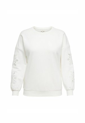 Sudadera blanca con mangas largas y abullonadas que presentan diseños florales recortados en las mangas inferiores. Hecha de una tela suave y texturizada.