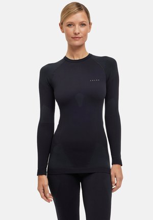 Zwarte sportieve top met lange mouwen, voorzien van een fitted ontwerp, textuuraccenten op de schouders en een logo op de borst. Glad, stretchy materiaal.
