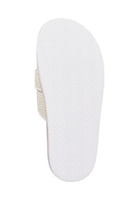 White sandal sole with a textured wavy pattern; lightweight design; side strap visible, crafted from woven material.