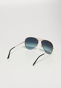 Aviator sunglasses with a gold metal frame, black temples, and gradient blue lenses. Features nose pads for comfort.