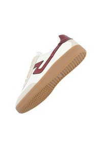 White and beige sneaker with brown rubber sole, featuring a maroon logo and textured detailing on the side, laced design, and smooth materials.