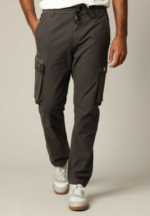 Pantalons cargo gris foncé, avec une coupe décontractée, une taille à cordon de serrage et plusieurs poches latérales zippées. Texture de tissu lisse.
