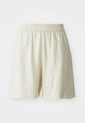 Shorts en lin, couleur crème, avec une taille élastique et une coupe ample. Design simple, texture lisse, sans motifs ni éléments métalliques visibles.