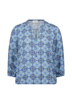 Blouse pour femmes à manches longues avec motif floral géométrique bleu et blanc, col en V et poignets élastiques sur fond blanc.