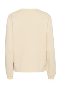 Sudadera beige de manga larga, con cuello redondo y puños acanalados. La tela parece lisa y suave, con un diseño sencillo de color sólido.