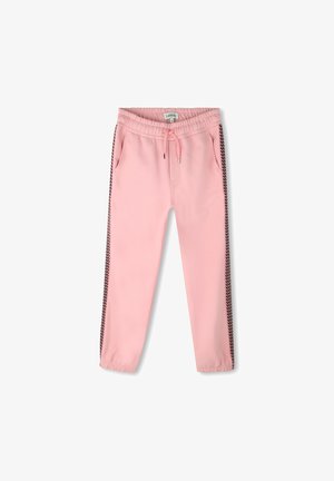 Różowe spodnie dresowe z elastycznym pasem, sznurkiem, bocznymi kieszeniami oraz czarnymi akcentami w zygzakowy wzór wzdłuż zewnętrznych szwów.