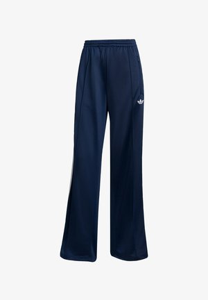 Navy blue athletic pants made from smooth fabric, featuring an elastic waistband and white logo detail on the left hip. Straight-leg design.