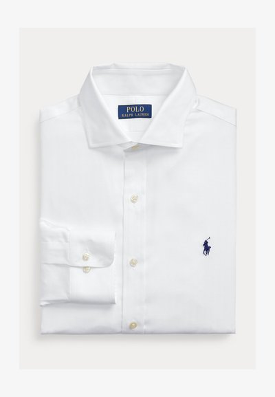 White long-sleeve dress shirt with a pointed collar, featuring pearl buttons and a small navy logo on the chest. Herringbone texture.