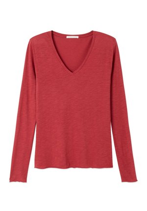 Maglia da donna a maniche lunghe color ruggine con scollo a V, tessuto leggermente strutturato e orlo dritto.