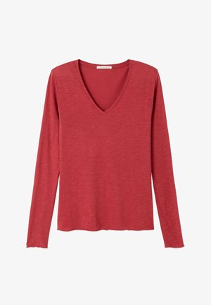 Maglia da donna a maniche lunghe color ruggine con scollo a V, tessuto leggermente strutturato e orlo dritto.
