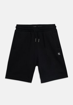 Czarne krótkie spodenki dzianinowe z bawełny z elastycznym pasem, sznurkiem, bocznymi kieszeniami i małą naszywką z logo Calvin Klein na lewej nodze.