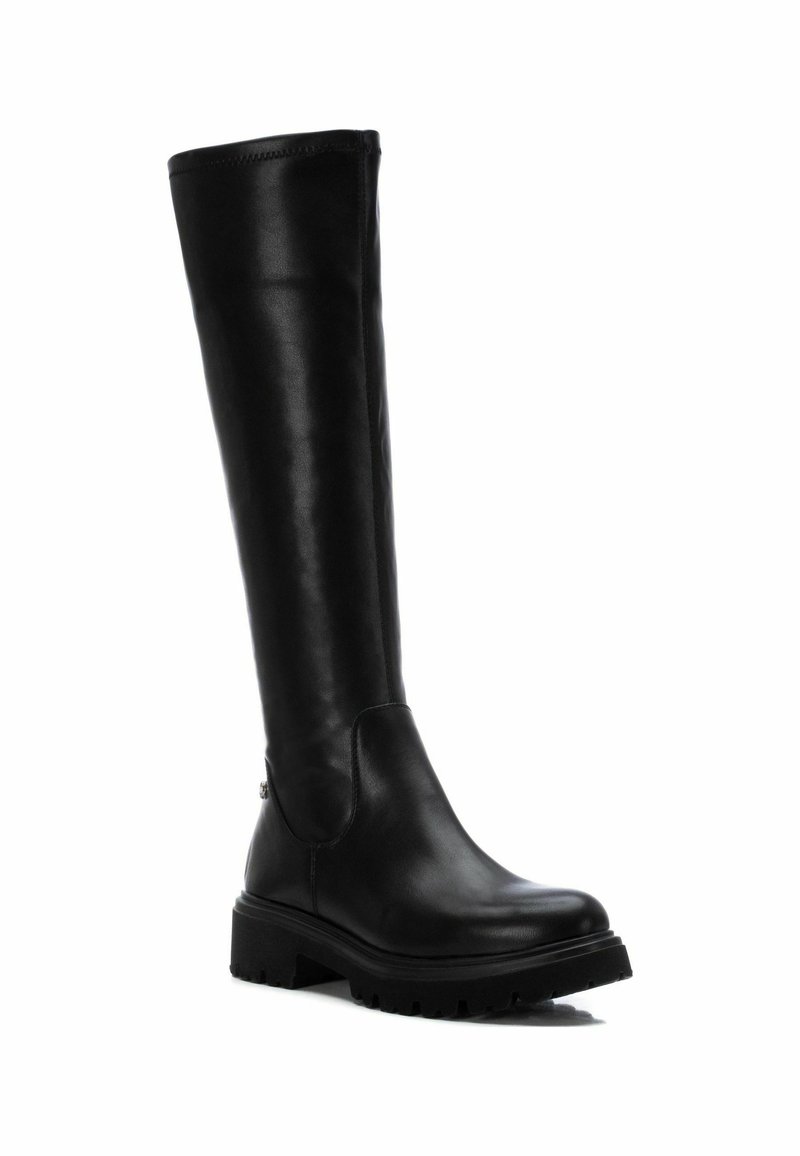 Bottes noires hauteur genou en cuir souple. Dotées d'un bout rond, d'une semelle en caoutchouc avec traction et d'un design épuré et minimaliste.