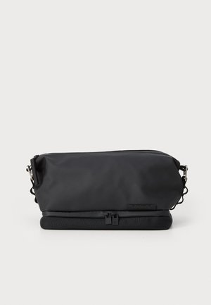 Saco preto, retangular, feito de material liso e resistente à água; possui fechos zíper, alça ajustável e uma base acolchoada para proteção.