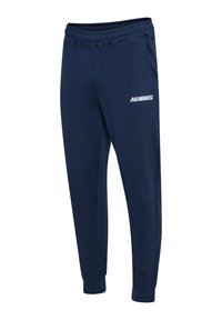 Marineblaue Jogginghosen mit tailliertem Schnitt, elastischem Bund, zwei seitlichen Taschen und einem weißen "HUMMEL"-Logo am linken Oberschenkel.