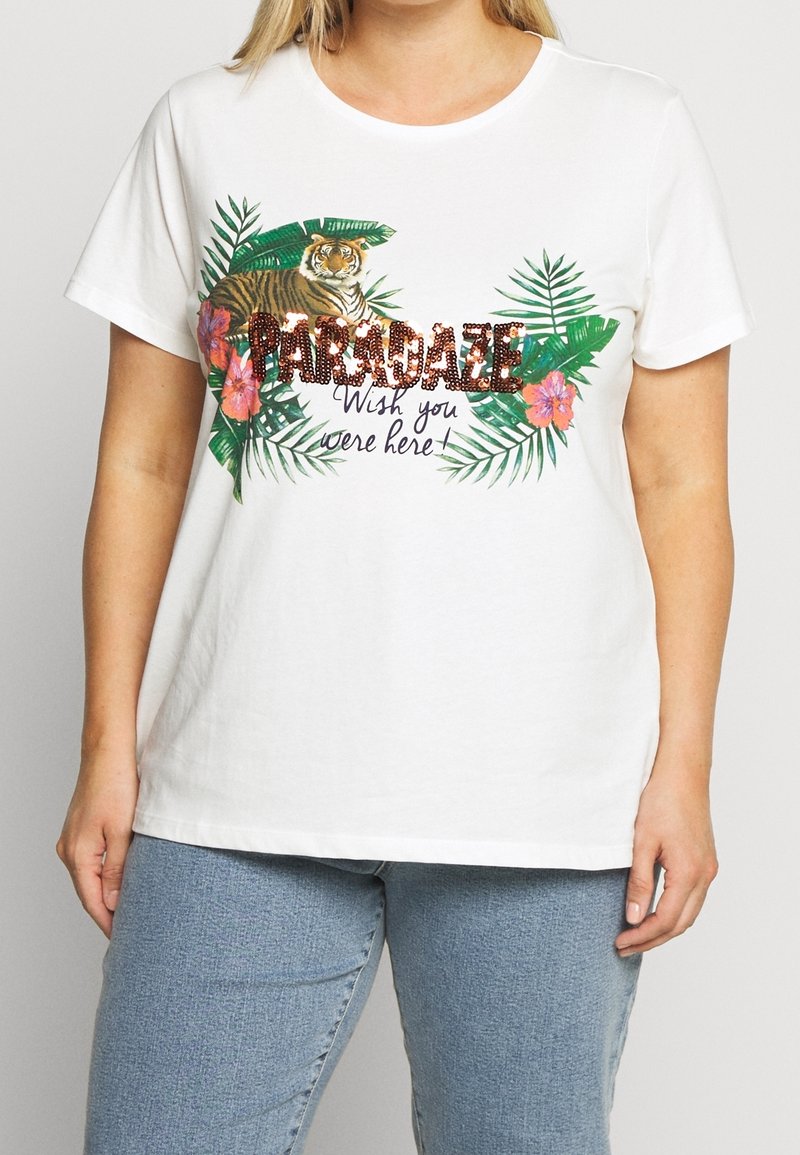 Vit bomull t-shirt med en tiger grafik, gröna blad och färgglada blommiga detaljer. Texten lyder "Paradaze Wish you were here!"