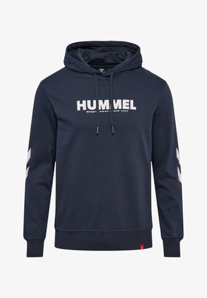 Hoodie bleu marine en mélange de coton, arborant le logo "HUMMEL" en gris clair, avec des accents en chevrons blancs sur les manches et une capuche ajustable.