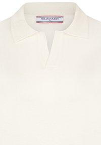 Crème-kleurige poloshirt met een gestructureerde kraag. Bevat een twee-knopen sluiting, lichte stof en een "FELIX HARDY" label.