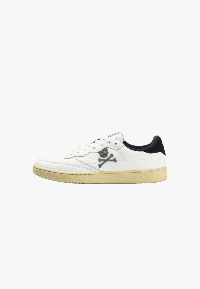 White sneaker with black accents, smooth leather material, round toe, lace-up design, and a skull and crossbones logo on the side.
