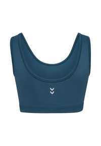 Turkos sport-bh i stretchigt material med en djup rundad urringning och subtil silverfärgad chevron-grafik framtill. Slät textur och minimalistisk design.