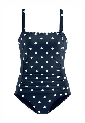 Costume da bagno blu navy a pois bianchi, con spalline regolabili, dettagli arricciati ai lati e scollatura a merletto, realizzato in un tessuto liscio e elastico.