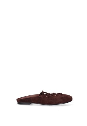 Brown suede flat mule with lace-up detail and a low black heel, shown from the side on a white background.