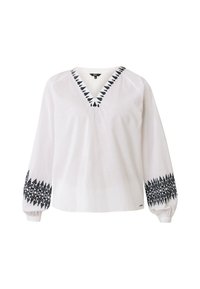 Camicia bianca a maniche lunghe con scollo a V, decorata con motivi di foglie ricamati neri lungo il collo e i polsini. Realizzata in tessuto leggero.
