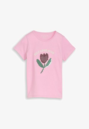 Roza majica s kratkimi rokavi, okrašena s turkiznim tulipanom iz bleščic in besedilom "SELF LOVE CLUB" nad cvetom, ki je osrednji motiv na sprednji strani.