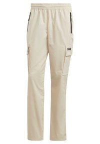 Pantalones cargo beige con cinturilla elástica, dos bolsillos con cremallera y bolsillos laterales tipo cargo. Tejido liso con una textura ligera.