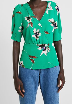 Blusa floreale verde con scollatura a V, maniche a palloncino corte e vita aderente. Realizzata in tessuto leggero con una finitura texturizzata.