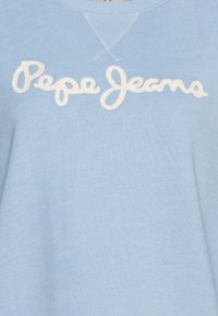 Light blue sweater made of knit fabric featuring an embroidered white logo "Pepe Jeans" across the chest. Simple crew neckline design.
