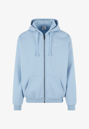 Light blue zip-up hoodie made of soft fabric. Features a hood, front pockets, ribbed cuffs, and hem, with a small white logo on the chest.