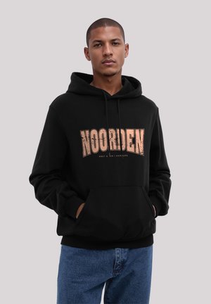 Black hoodie with large "NOORDEN" graphic in distressed rose gold, drawstring hood, and front pocket, paired with blue jeans.