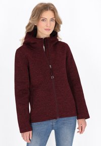 Burgundy hooded jacket with textured fabric, front zipper, and two side pockets. Features a high collar and elastic cuffs.