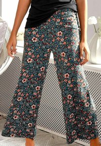 Floral print wide-leg pants featuring a dark background with multicolored flowers, elastic waistband, and lightweight material.