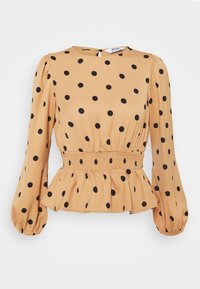 Beige långärmad blus med svarta prickar, samlad elastisk midja, peplumslut och knappstängning i nacken.