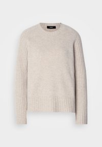 Lys beige strikket genser med rund hals, ribbestrikkede ermer og ribbestrikket kant. Laget av mykt materiale med en teksturert overflate.