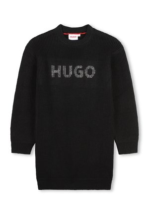 Pull en tricot noir avec un col rond, arborant le mot "HUGO" en clous argentés sur le devant. Manches longues et poignets côtelés.
