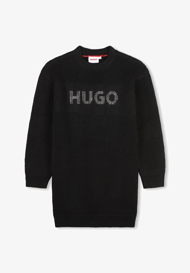 Pull en tricot noir avec un col rond, arborant le mot "HUGO" en clous argentés sur le devant. Manches longues et poignets côtelés.