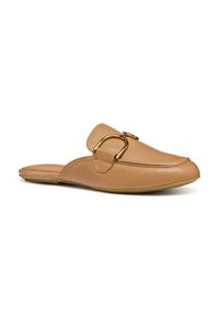 Tan leather slip-on shoe with a rounded toe, featuring a wide strap and a gold buckle accent. Smooth texture with a flat sole.