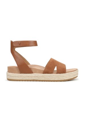 Tan leather and suede sandal with two wide cross straps and ankle strap. Jute-woven platform sole, flat, with rubber bottom for traction.