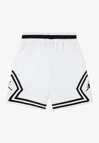 White athletic shorts with black accents, featuring a mesh texture, elastic waistband, and a black Jumpman logo on the side.