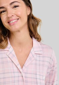 Camisa de pijama de cuadros rosas con una textura suave, con cuello con muesca, cierre de botones y un pequeño bolsillo en el pecho.
