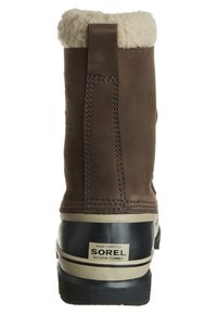 Brown leather boot with a fluffy white lining at the top, black rubber sole, tan accents, and a label stating "SOREL" on the heel.