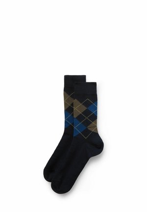 Navy blue socks featuring an argyle pattern with dark blue, brown, and green diamonds, crafted from soft, stretchy material.