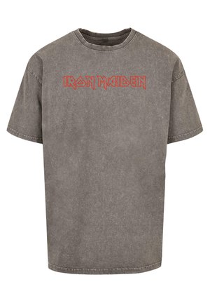 Gray oversized cotton t-shirt featuring a faded finish and red "Iron Maiden" lettering across the chest. Short sleeves and round neckline.