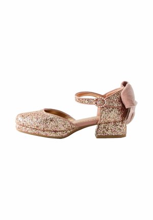 Glittery pink ankle strap shoe with a square toe, featuring a low block heel and a velvety bow accent on the back.