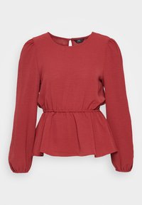 Rød peplum top med lange ærmer, rund halsudskæring og en samlet talje. Lavet af struktureret stof med en nøglehul-detail på ryggen og elastiske manchetter.