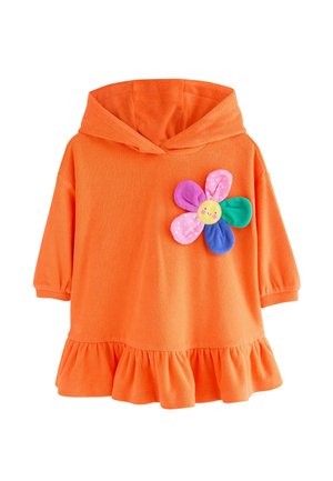 Orange huva tunika med volang nog, som har en flerfärgad blommor applikation med ett leende ansikte, tillverkad av mjukt tyg.
