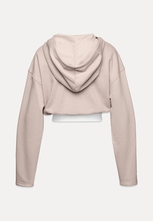 Trumpu dizaino smėlio spalvos džemperis su ilgomis rankovėmis ir didele kapučiuku. Apačioje yra balta elastinga juosta. Minkšta medžiaga su švelniu tekstūra.